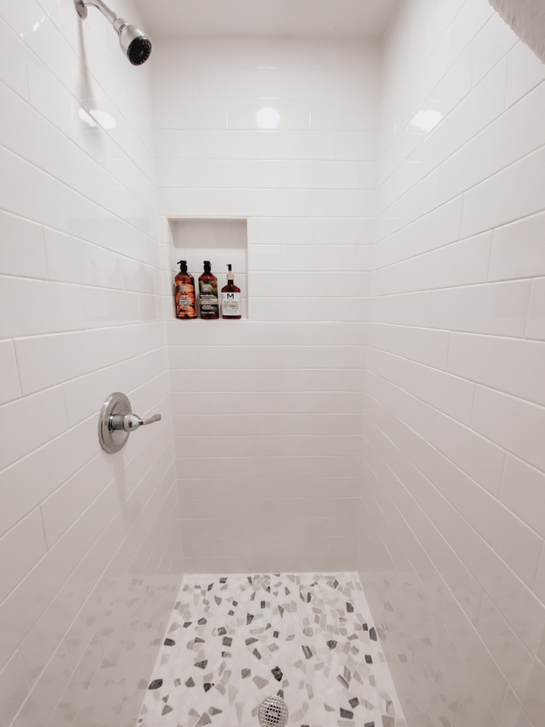 view inside white tile shower 