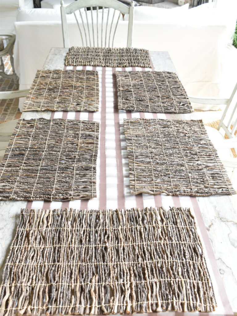 brown and white plaid paper table runner on outdoor rustic long dining table and 6 twig placesmats