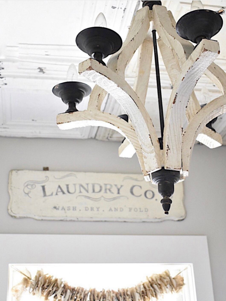 white light fixture with laundry room sign in background