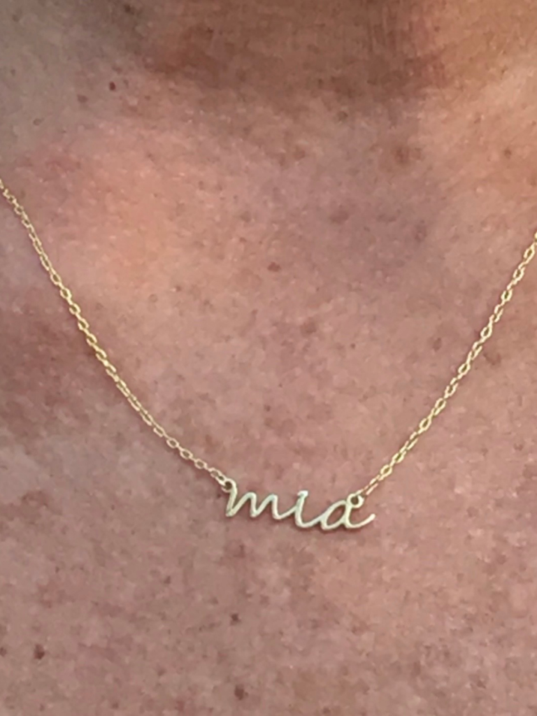 gold personalized necklace that says mia