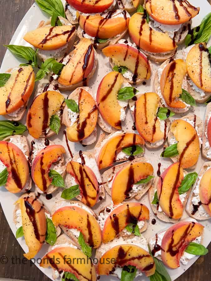 peach and goat cheese bruschetta on white platter