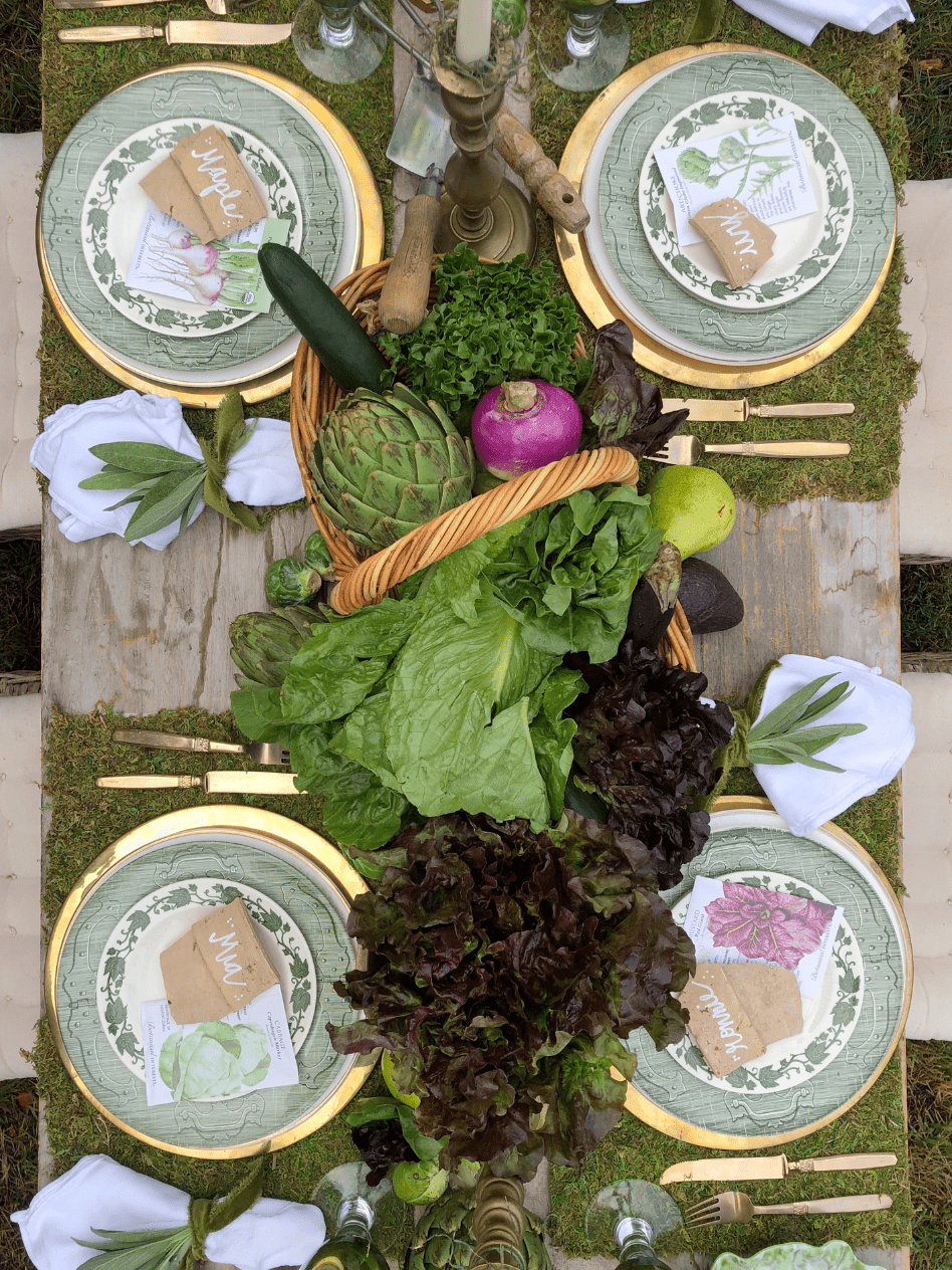 fall garden party tablescape using fresh veggies, terra cotta pot, brass candlesticks cabbage plates