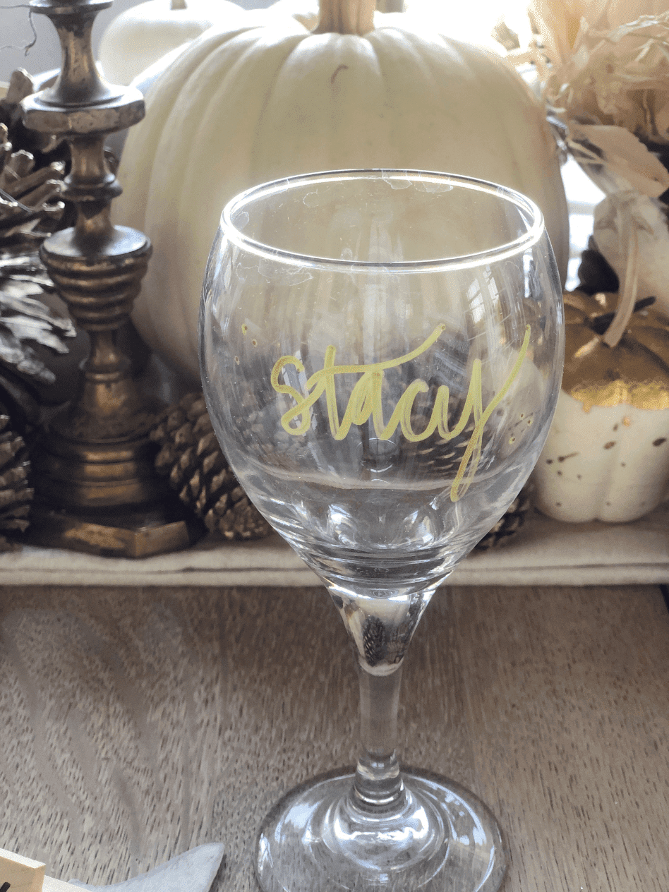 clear wine glass with guest name in gold writing