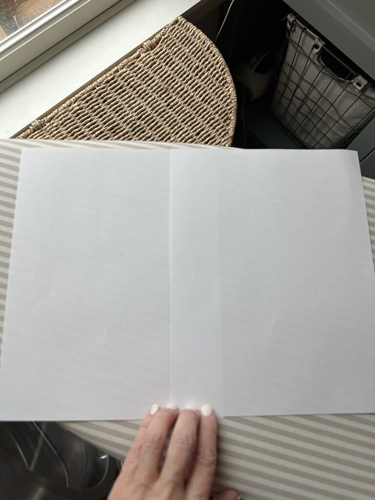 white paper laying on ironing board