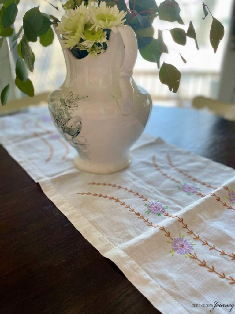 ironstone pitcher with flowers on table centerpiece