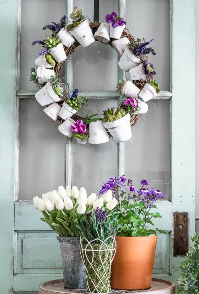 spring wreath made with painted white peat pots and faux flowers and greenery