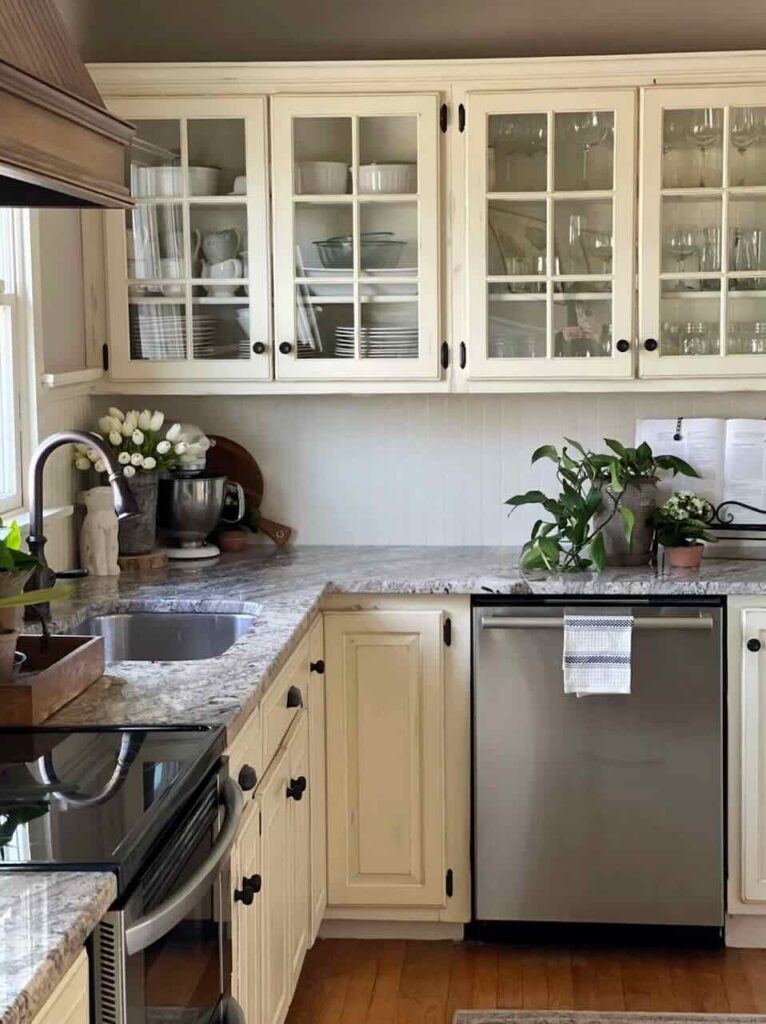 kitchen with white glass front cabinets