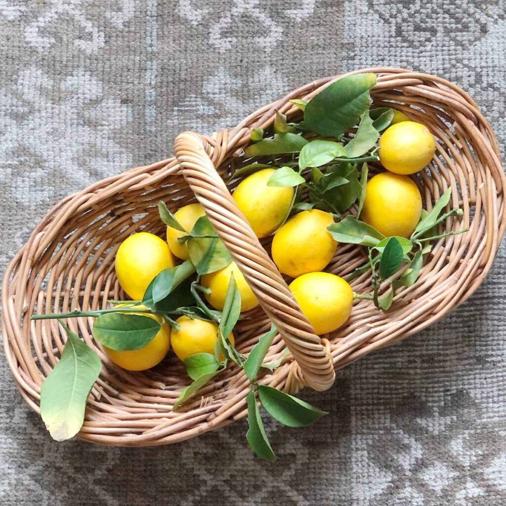 wicker basket with handle filled with lemons 