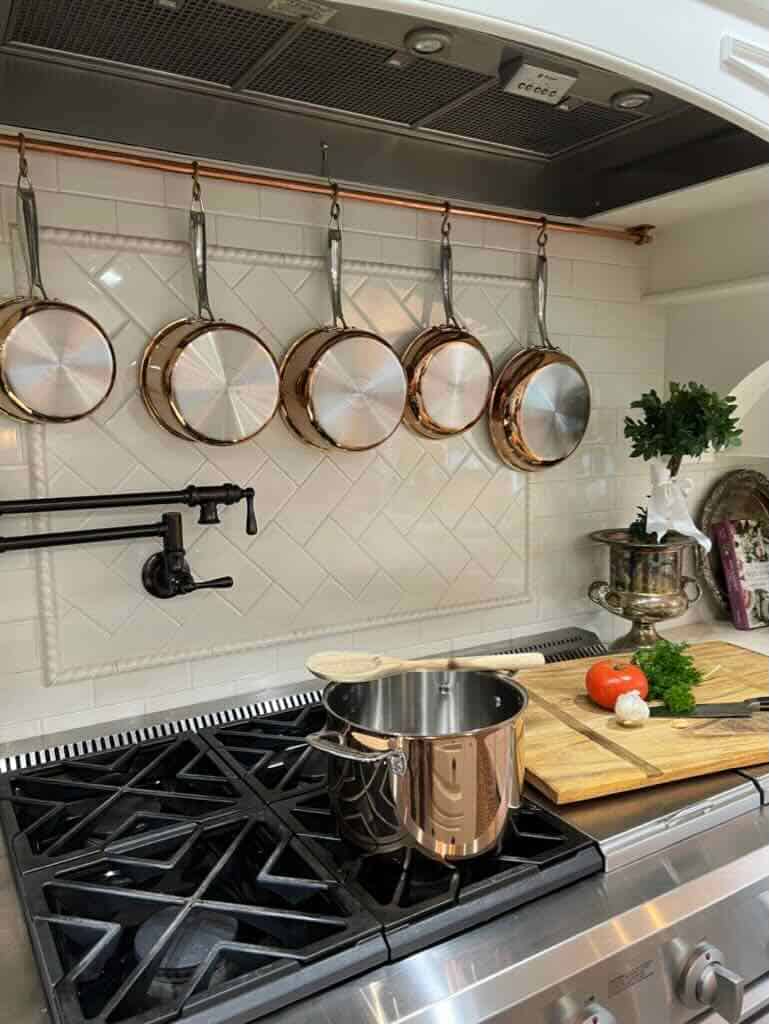 copper pots hanging over stove