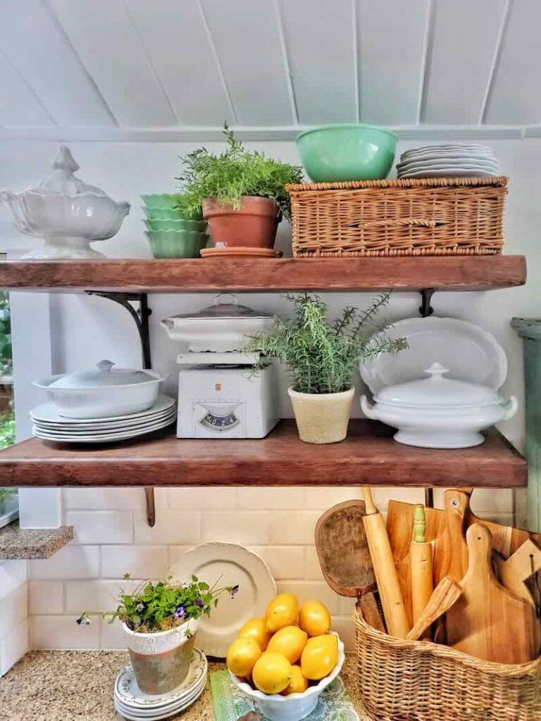 open shelving with white dishes and baskets