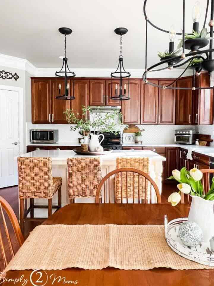 kitchen with wood cabinets white countertops woven barstools