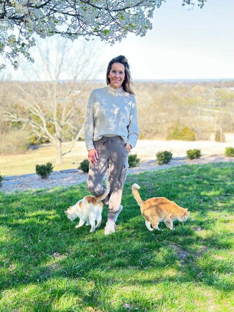 woman in taupe joggers standing outside