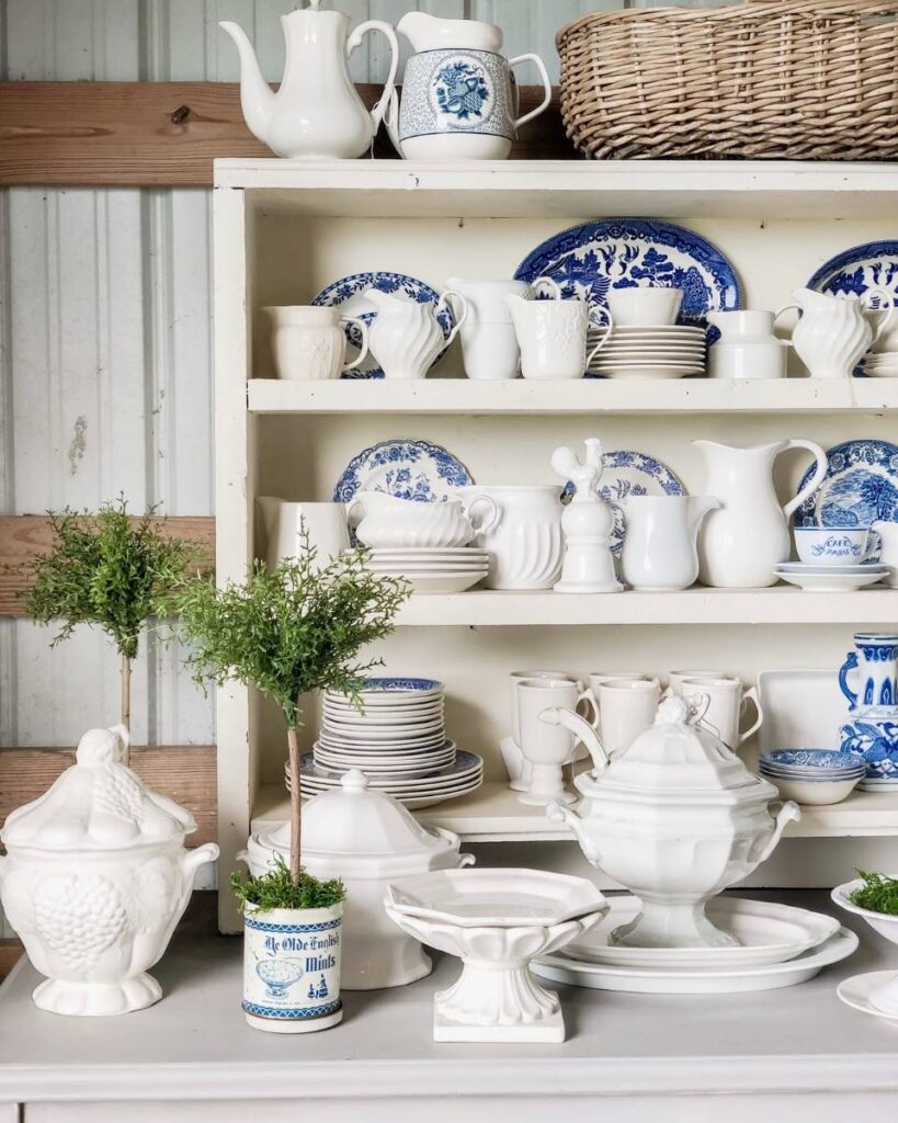 barn sale display white shelves filled with blue and white dishes