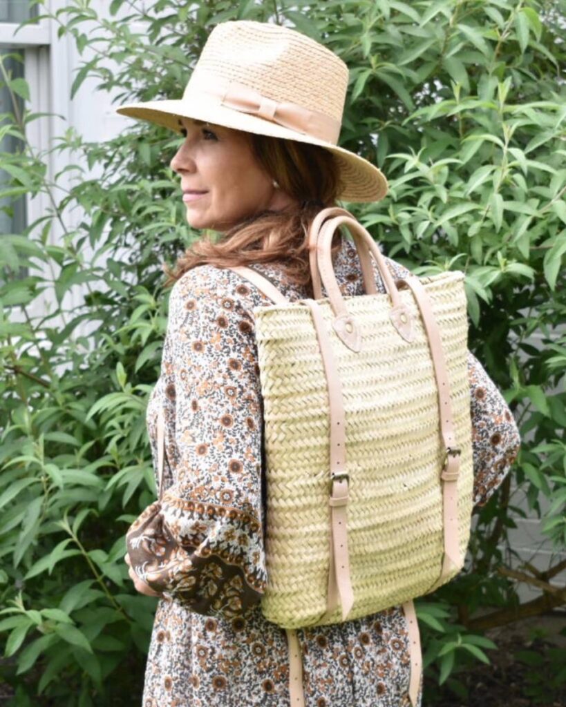 female with straw backpack and straw hat