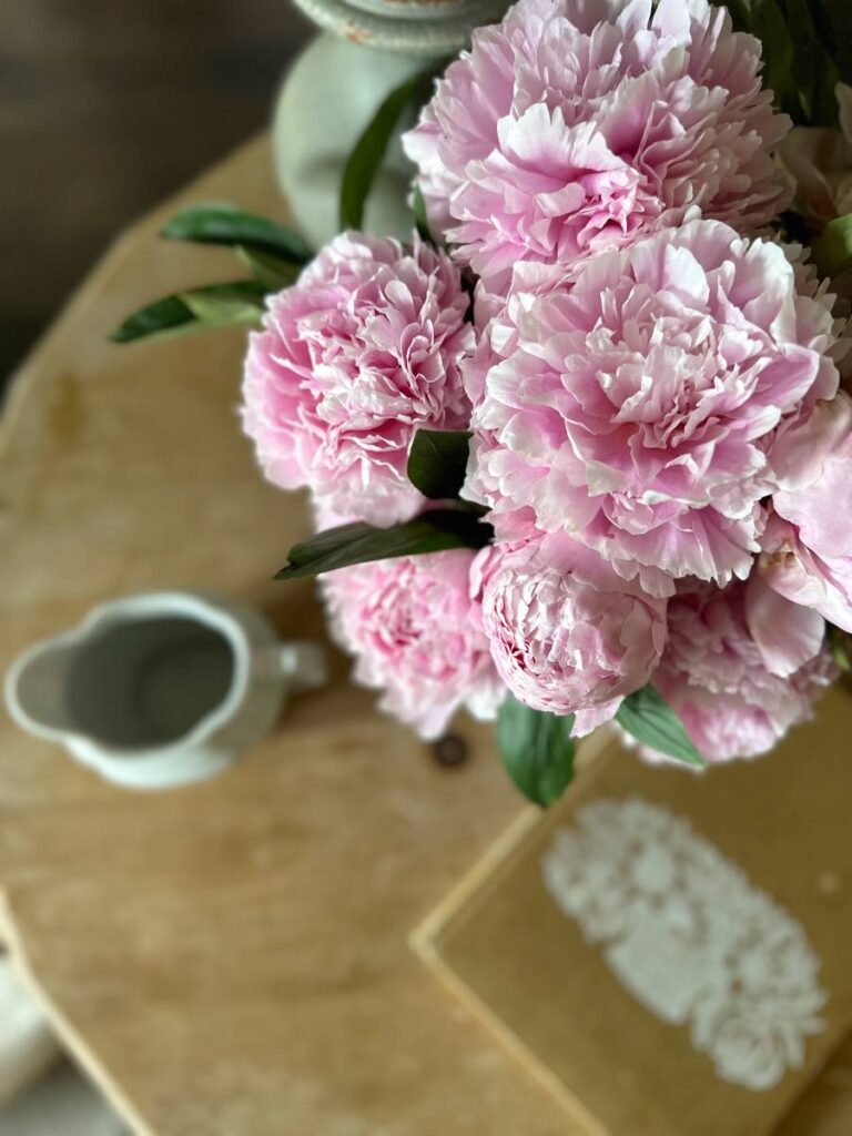 pink peonies on wood tabletop