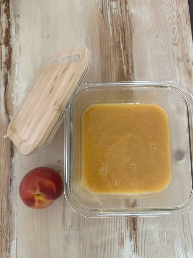 peach soup in clear glass container