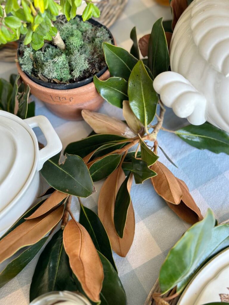 magnolia leaves and branches in center of table for southern style dinner party