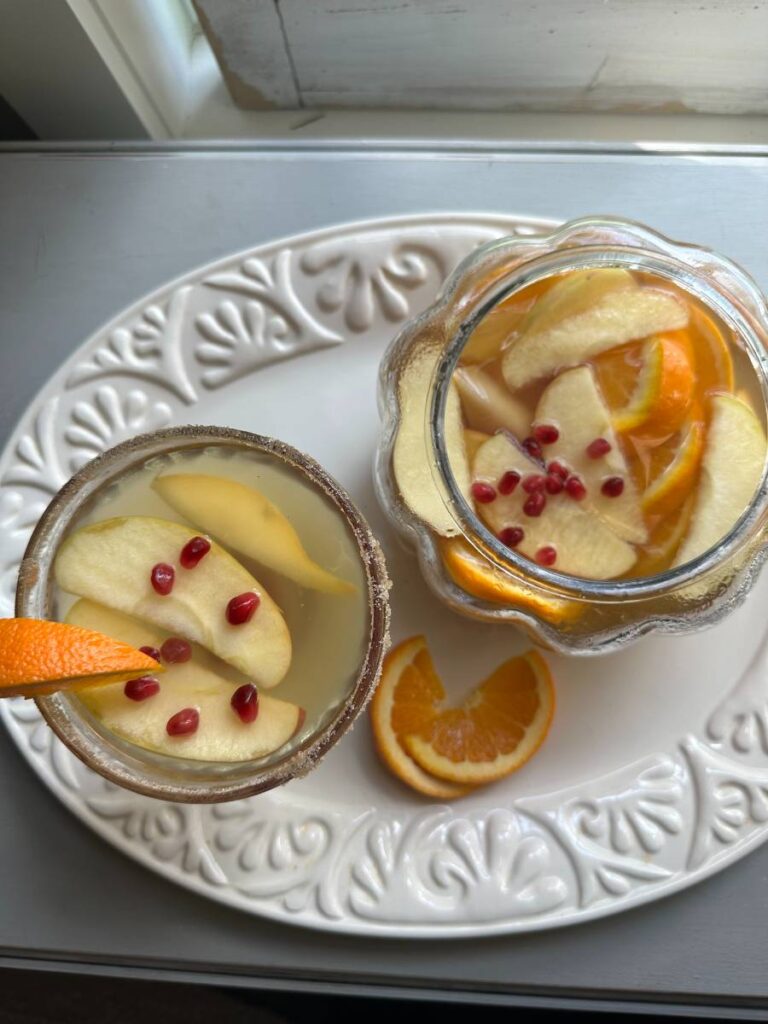 martini glass and pumpkin shape punch bowl with pumpkin apple cider sangria