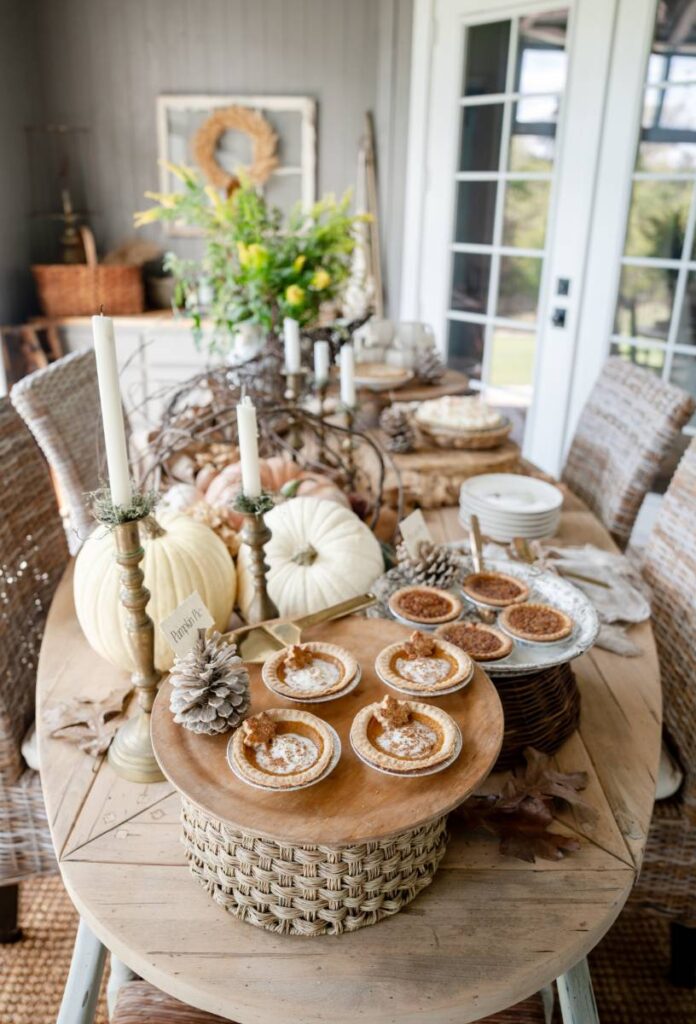 PIe buffet table for Thanksgiving cornucopia with pumpkins centerpiece wooden and woven cake plates/risers large pies and mini pies on cake stands