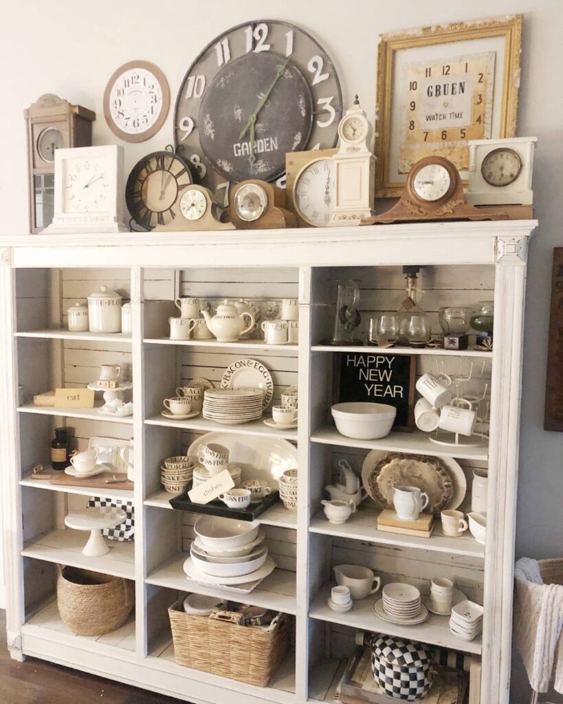 kitchen hutch with collection of vintage clocks on top