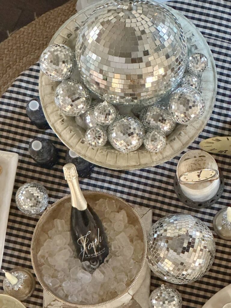 overhead view of black and white theme table set for New Year's charcuterie board party overhead view of black and white theme table set for New Year's charcuterie board party vintage clocks disco balls for decor