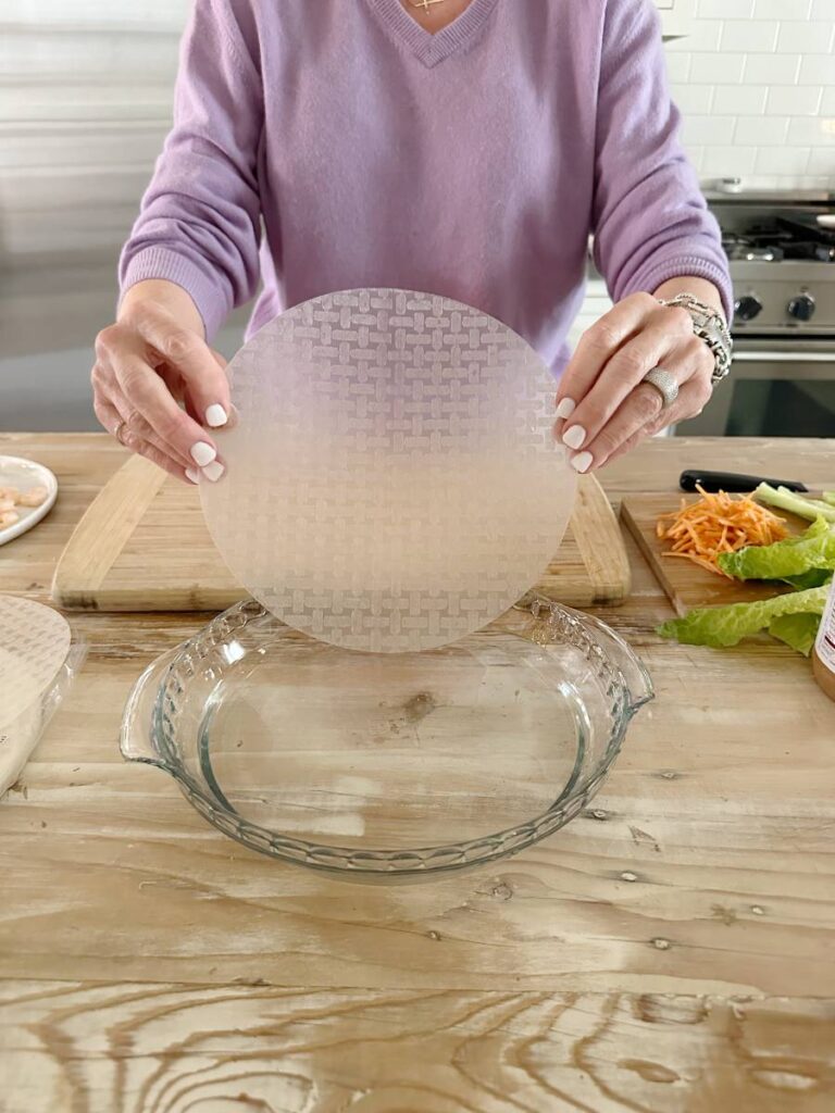 rice paper wrappers being dipped in water