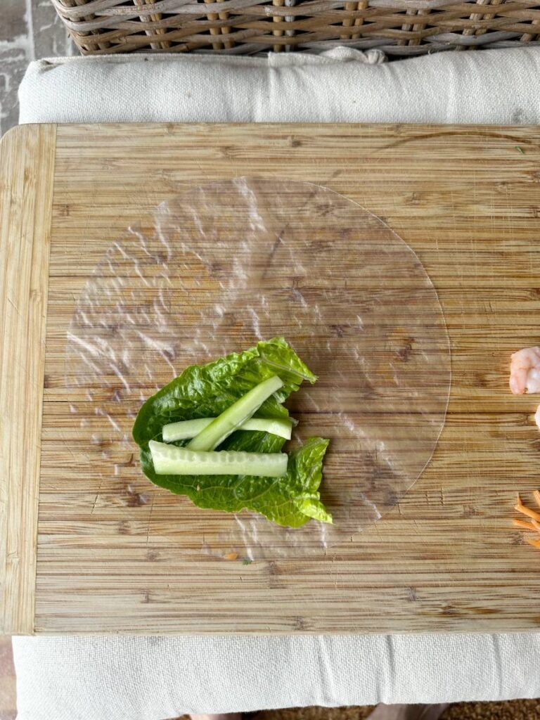 lettuce leaf and cucumber slices on rice paper wrapper for spring roll