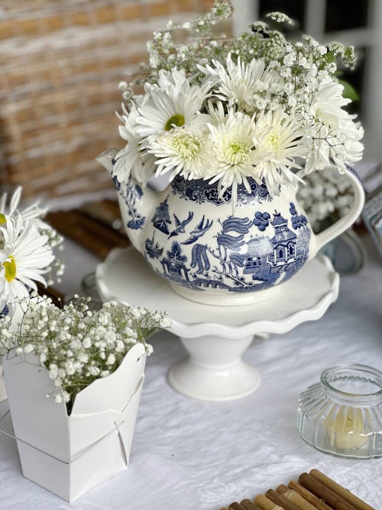 blue asian pattern teapot with white flowers for table centerpiece