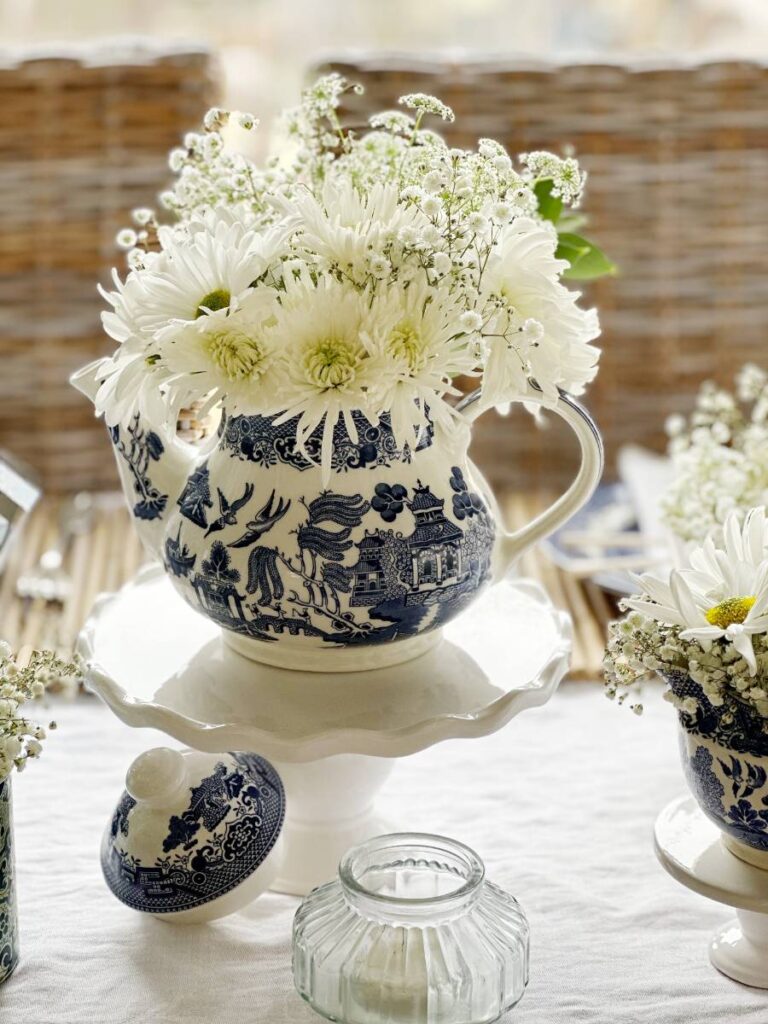 blue asian pattern teapot with white flowers for table centerpiece