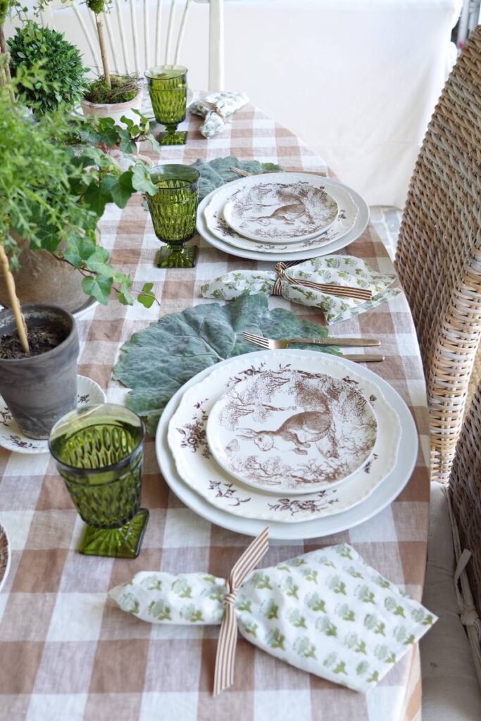 brown pattern bunny plate green block print napkin gold flatware on cabbage leaf placemat for spring place setting