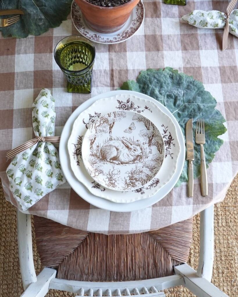 brown and white check tablecloth green print napkin brown bunny plate on cabbage leaf placemat