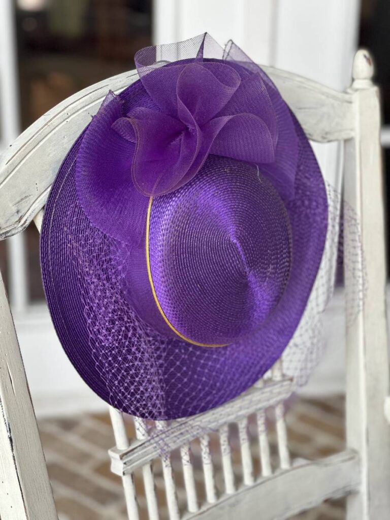 purple fancy hat on back of chair for Kentucky Derby table setting