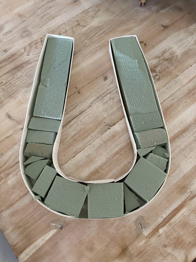 cardboard horse shoe shape filled with floral foam for floral decor for Kentucky Derby table