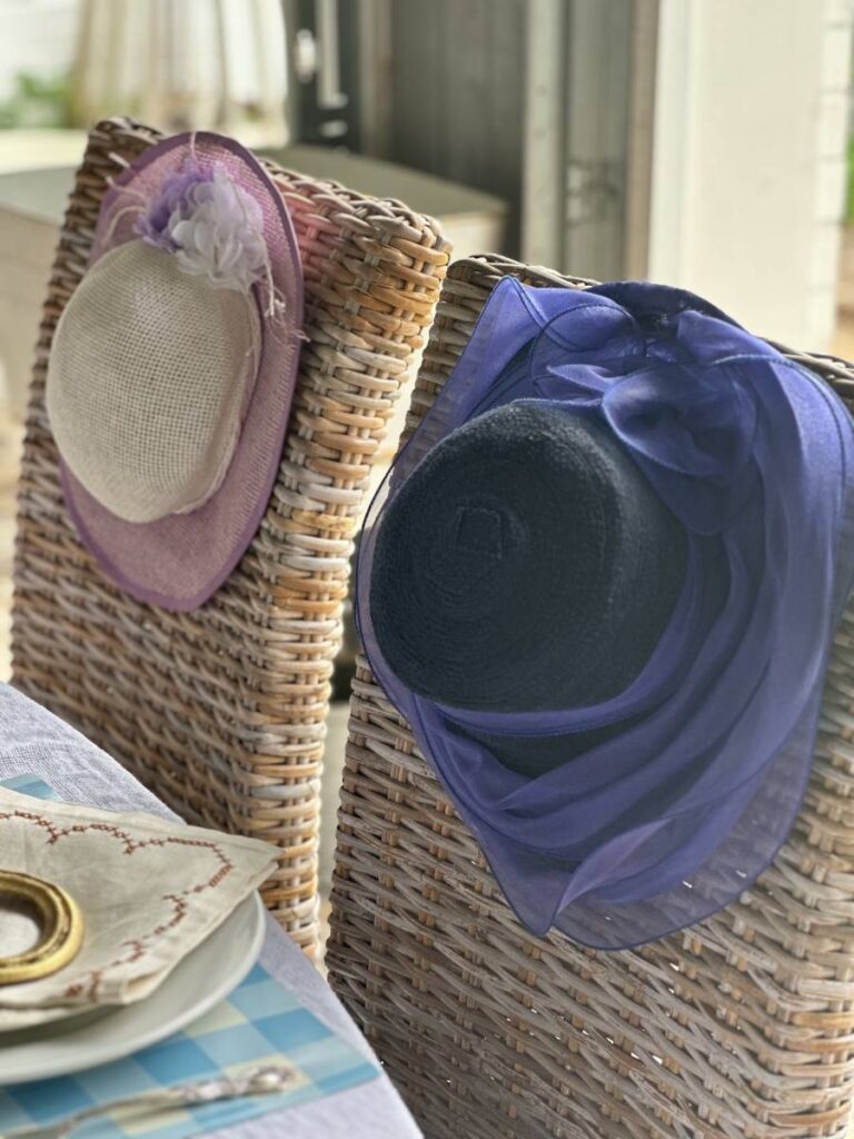 fancy hat on the back of two chairs for Kentucky Derby table decor