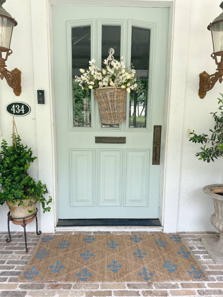 blue block print pattern on jute rug runner outside front light blue front door