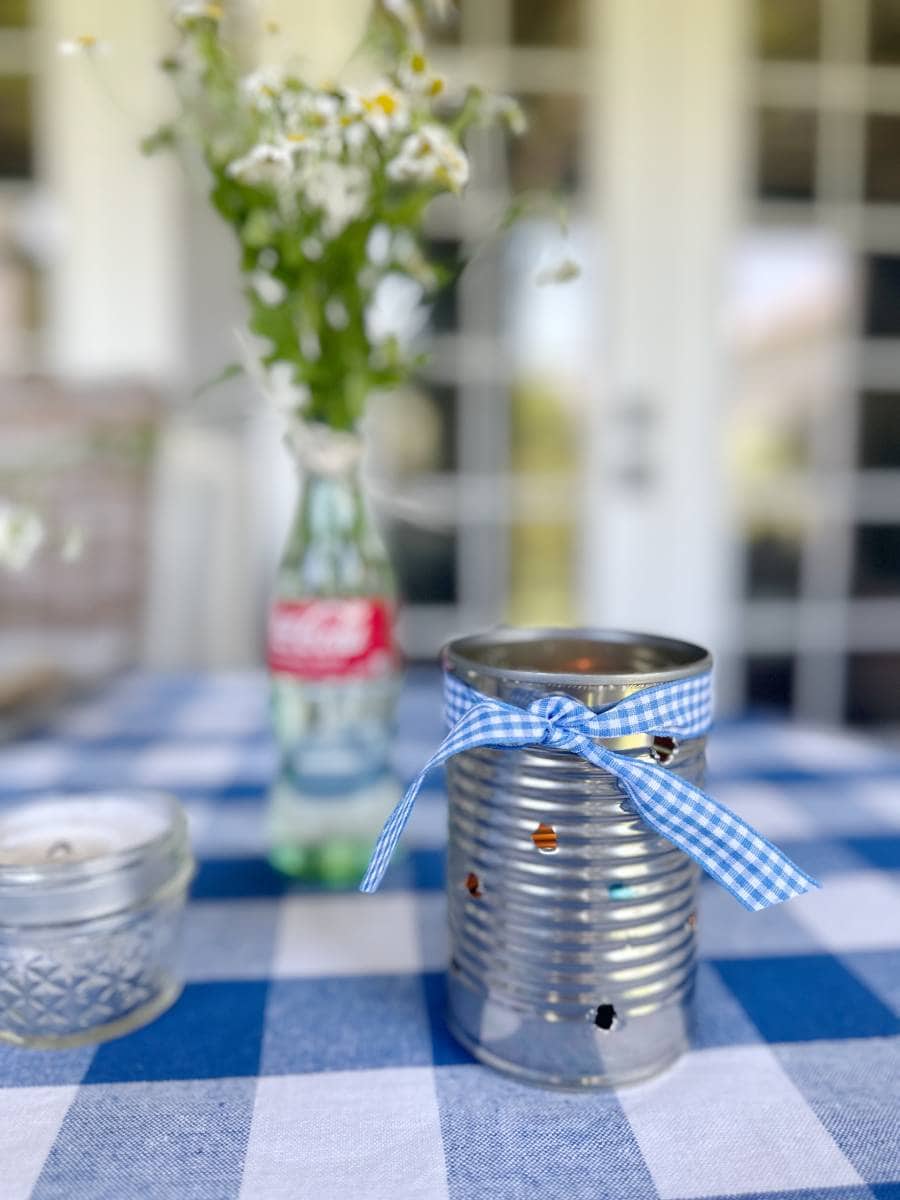 tin can with holes drilled and candle inside for table luminaria