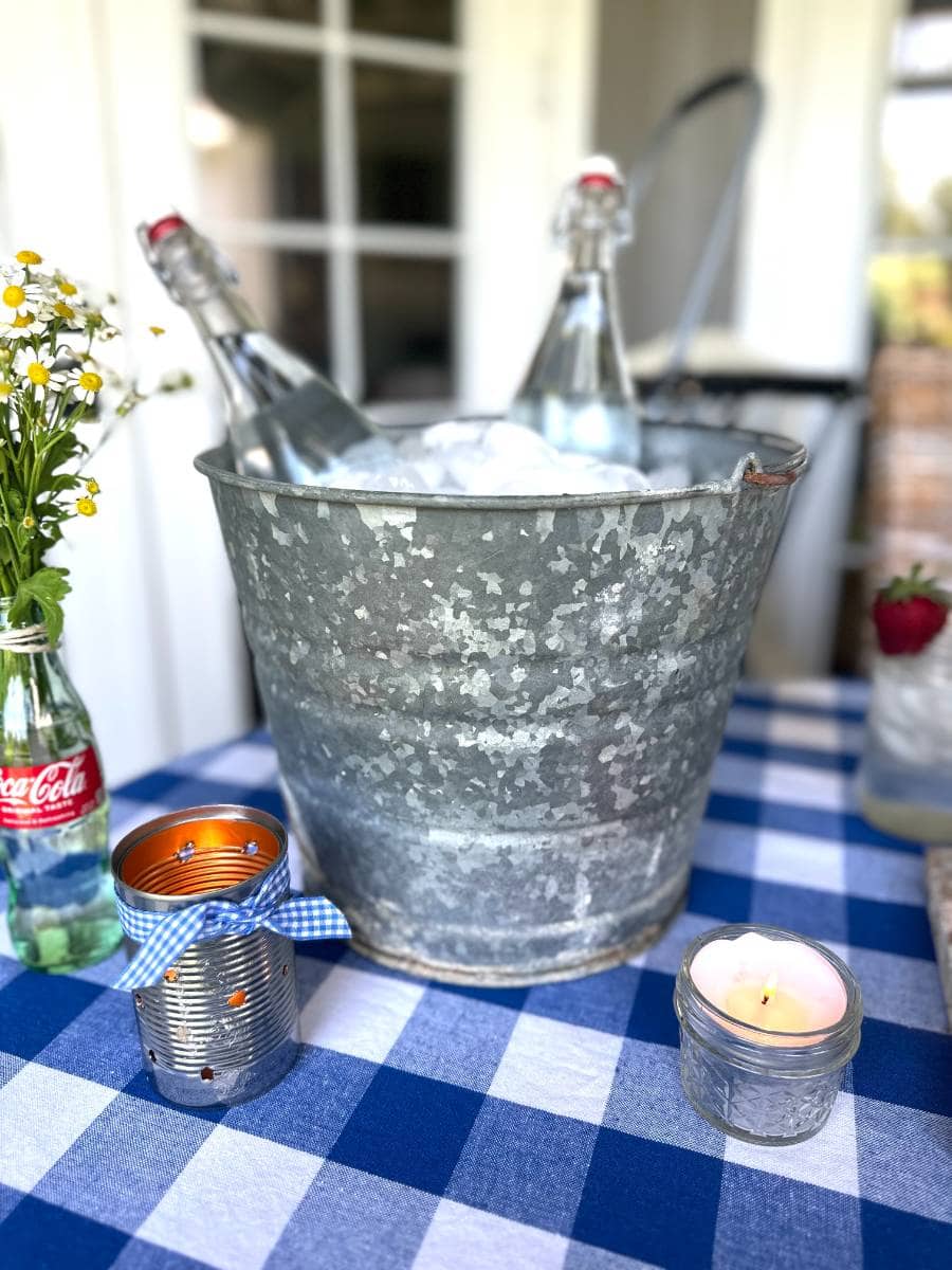 metal bucket filled with ice and 2 glass bottles filled with water
