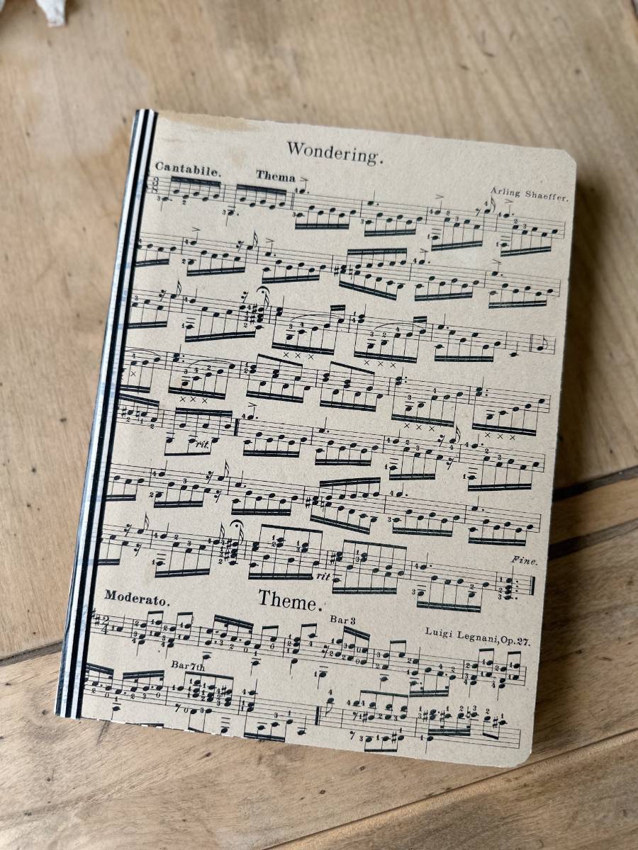 handmade journal notebooks with sheet music on cover and washi tape on binding