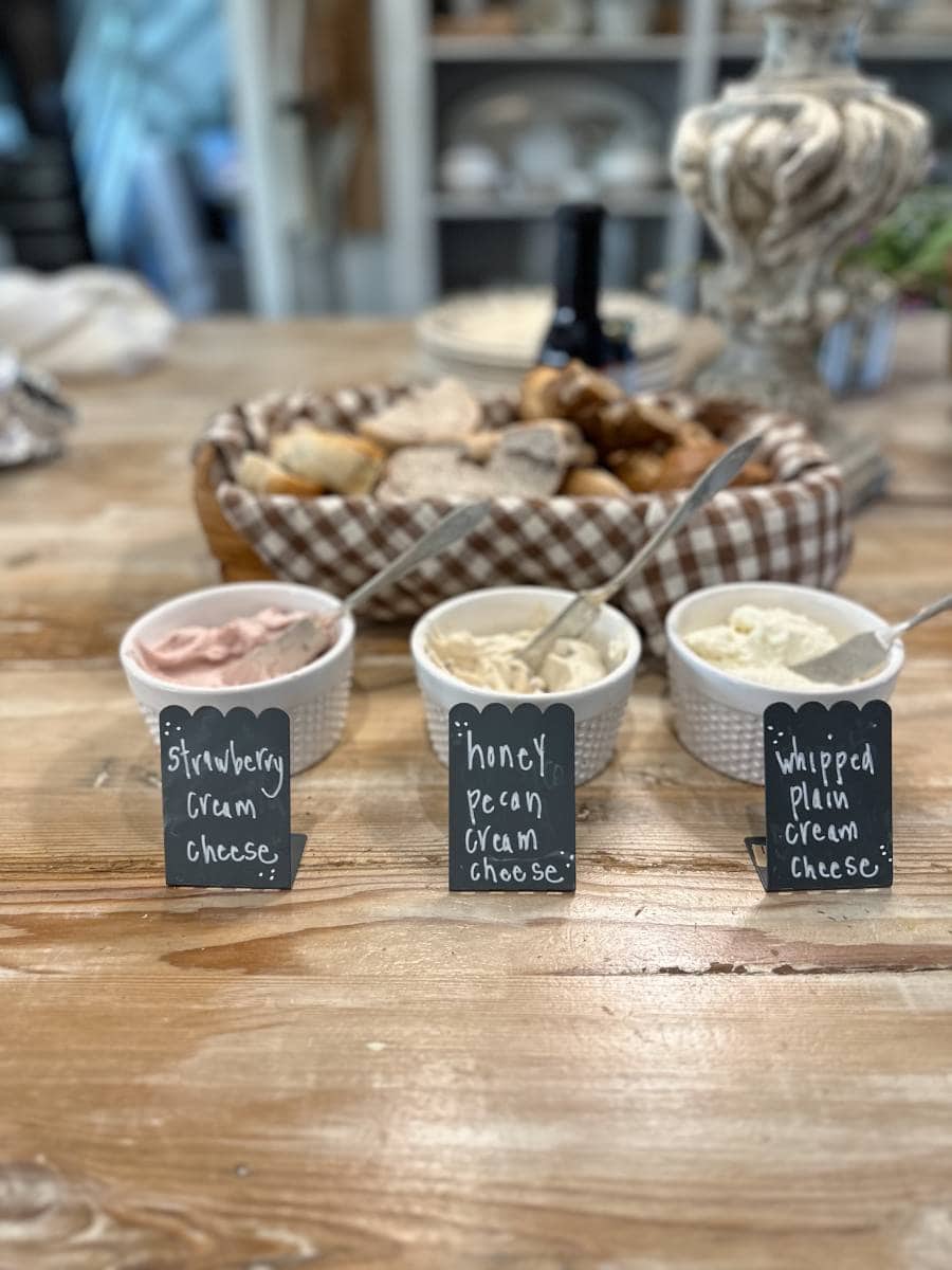 basket of bagels and 3 flavors of cream cheese for breakfast buffet