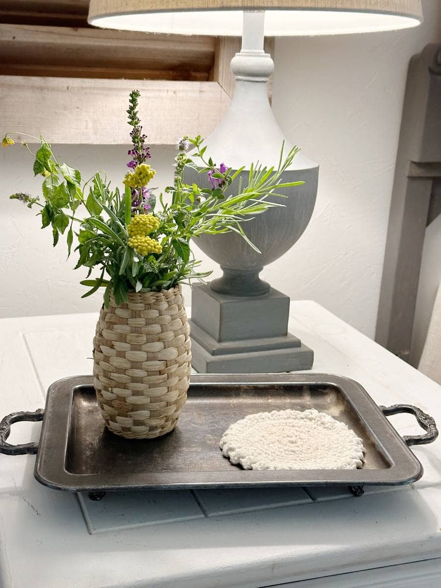 vase of flowers beside guest bed for girls retreat